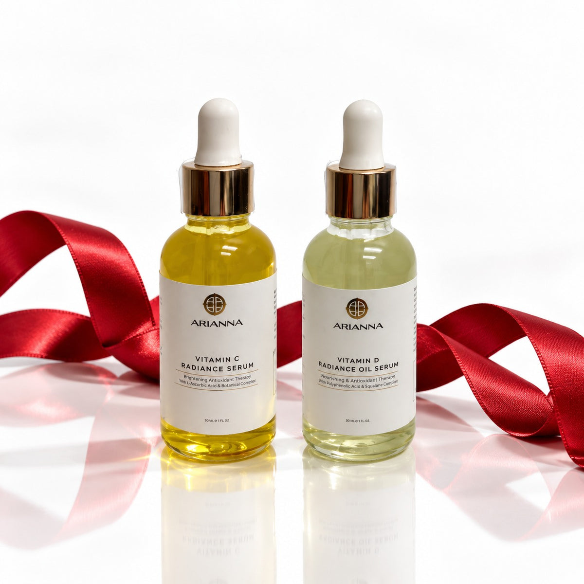 The Vitamin Glow Ritual: Vitamin C Radiance Serum and Vitamin D Radiance Oil Serum with a red satin ribbon