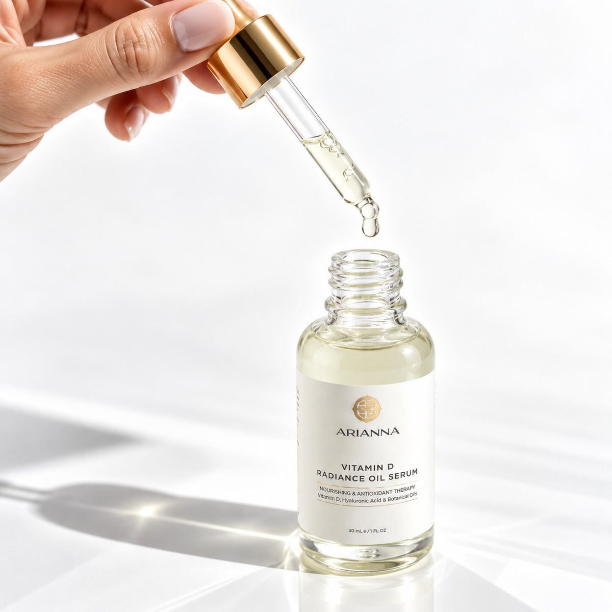 Vitamin D Radiance Oil Serum dropper with a golden drop of oil